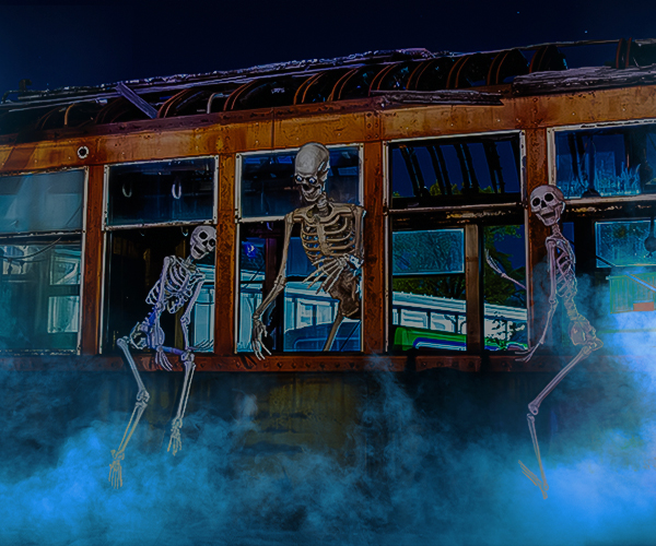 Scary skeletons crawling out of the windows of an abandoned trolley car with smoke rolling in, creating a spooky scene for this year's Ghost Trolley at the Ohio Railway Museum.